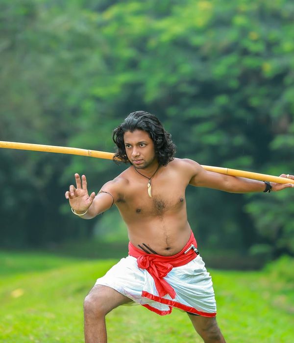 Man performing a strength exercise in a calm, focused environment.